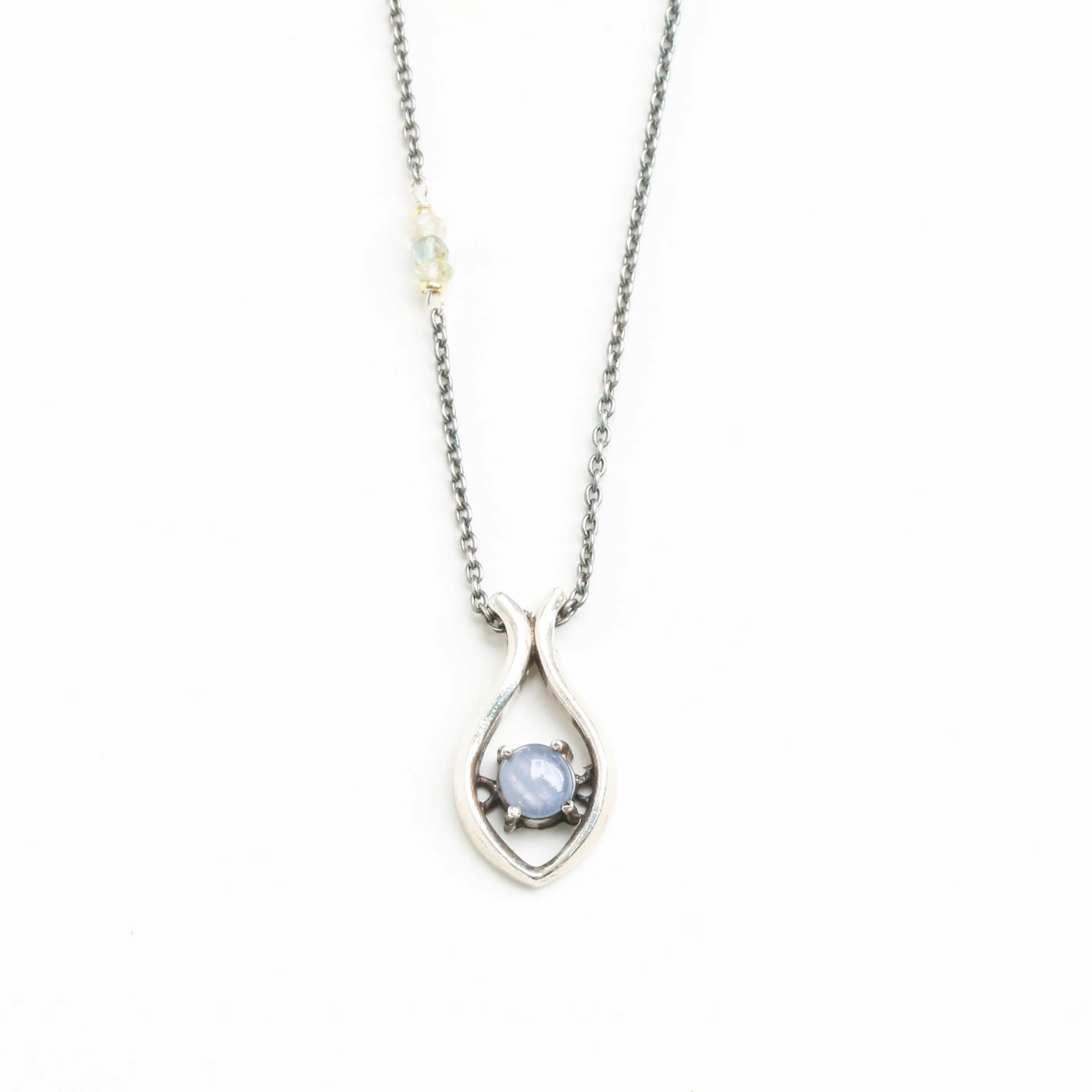 Silver fish shape necklace and cabochon star blue sapphire at the center with aquamarine beads secondary on oxidized sterling silver chain